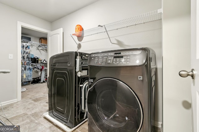 laundry area with washing machine and dryer, laundry area, and baseboards