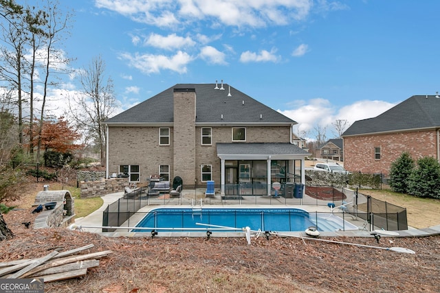 view of swimming pool featuring a fenced in pool, a sunroom, a patio, and fence