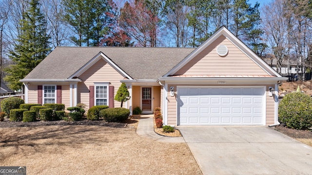 single story home with a garage, concrete driveway, and a shingled roof