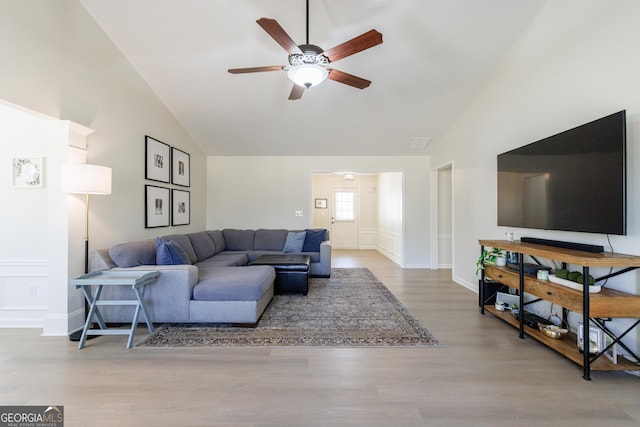 living room featuring high vaulted ceiling, a ceiling fan, and wood finished floors