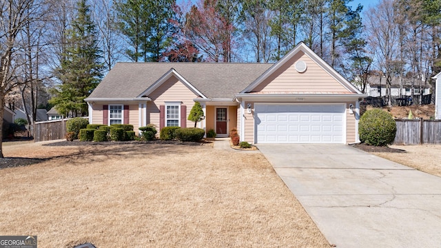 ranch-style house with concrete driveway, a front lawn, an attached garage, and fence