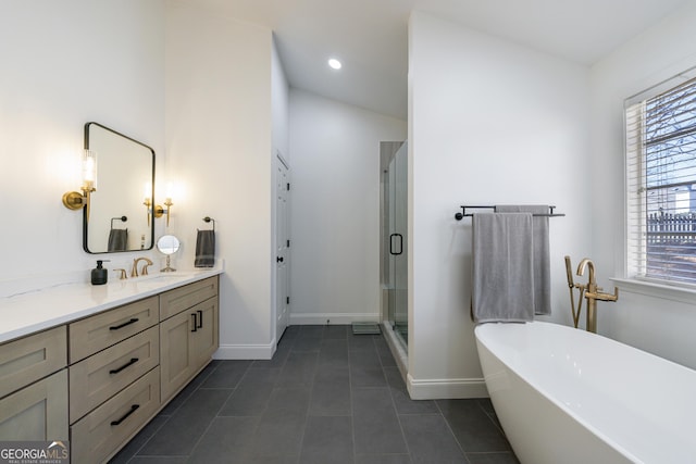 bathroom with a soaking tub, a stall shower, vanity, baseboards, and tile patterned floors