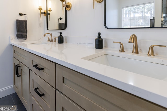 bathroom with tile patterned floors, a sink, and double vanity