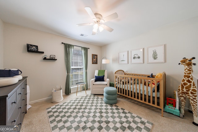 bedroom featuring ceiling fan, carpet floors, visible vents, baseboards, and a nursery area