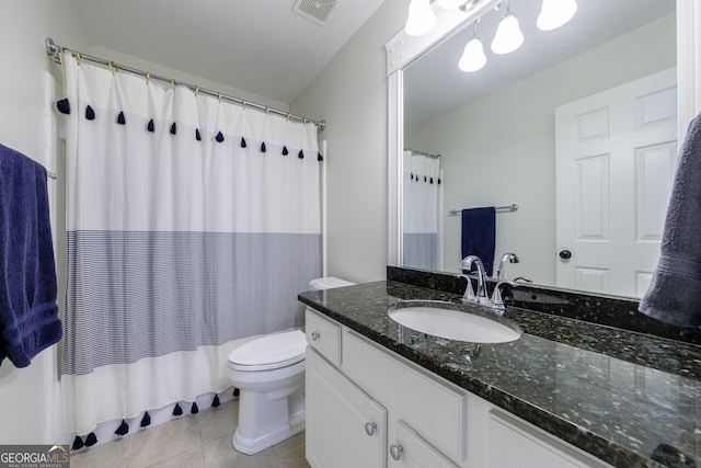 bathroom featuring tile patterned flooring, toilet, vanity, visible vents, and shower / bath combo