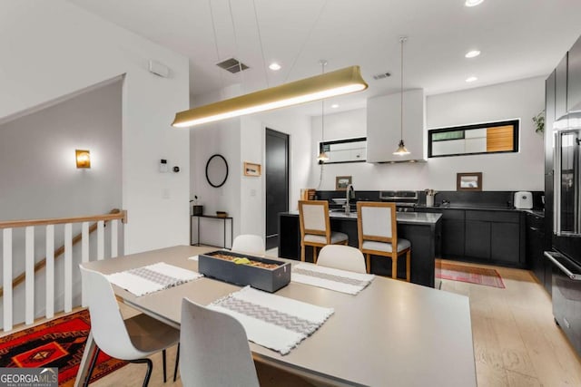 dining space with recessed lighting, visible vents, and light wood-style flooring