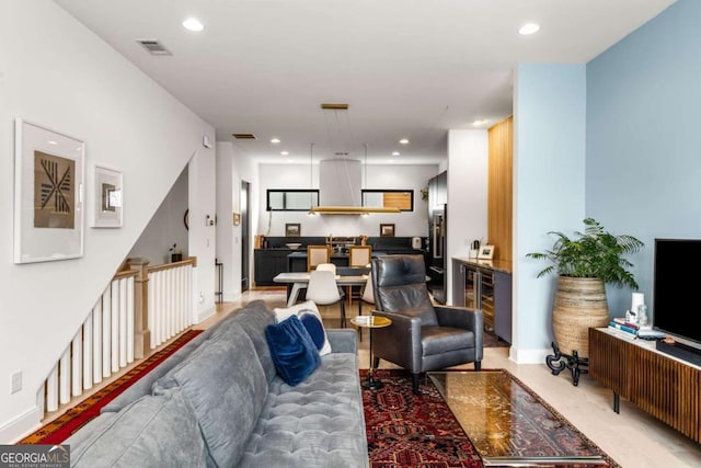 living room featuring baseboards, visible vents, and recessed lighting