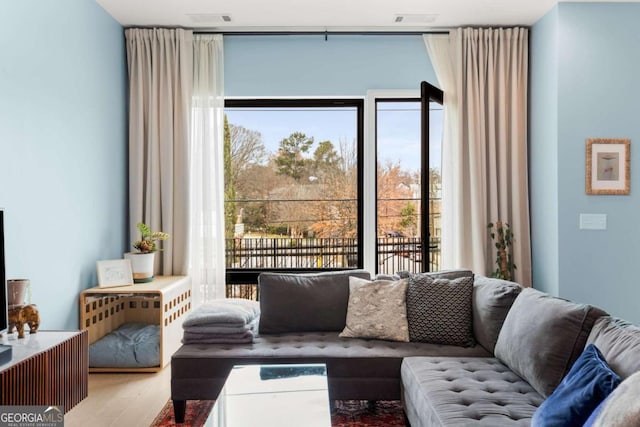 living room with wood finished floors and visible vents