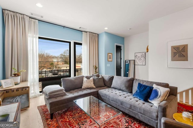 living room featuring recessed lighting, visible vents, and wood finished floors