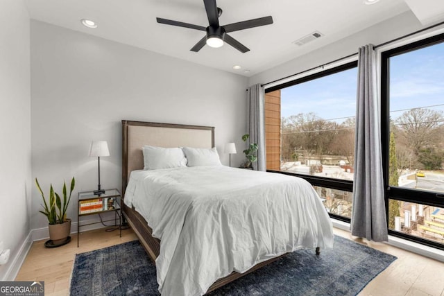 bedroom with baseboards, visible vents, ceiling fan, wood finished floors, and recessed lighting