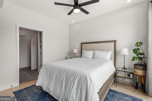 bedroom featuring wood finished floors, a ceiling fan, and recessed lighting