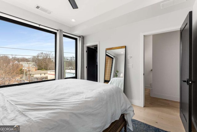 bedroom with recessed lighting, wood finished floors, visible vents, and baseboards