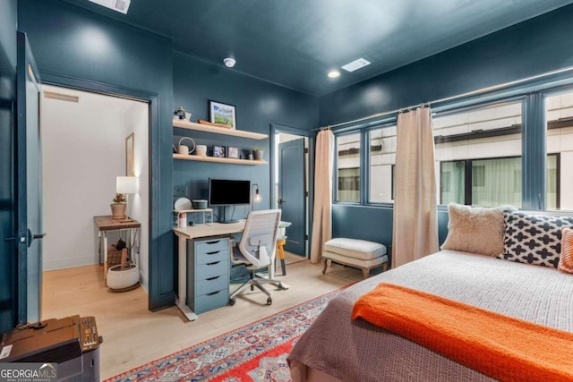 bedroom featuring visible vents and wood finished floors