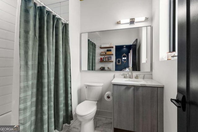 full bathroom with marble finish floor, a shower with shower curtain, vanity, and toilet