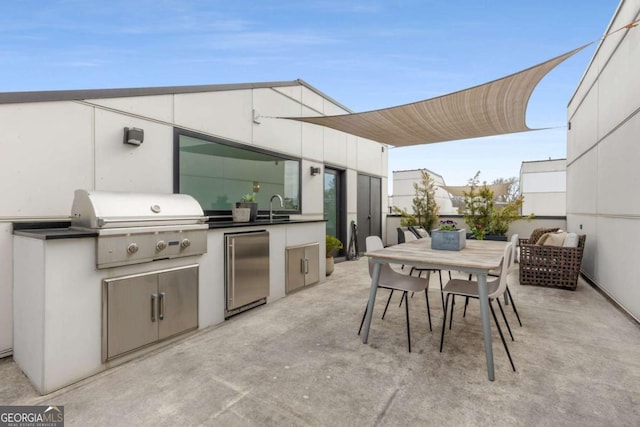 view of patio / terrace featuring outdoor dining area, a sink, grilling area, and area for grilling