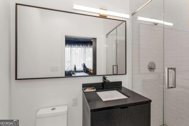 full bath with toilet, a shower stall, and vanity