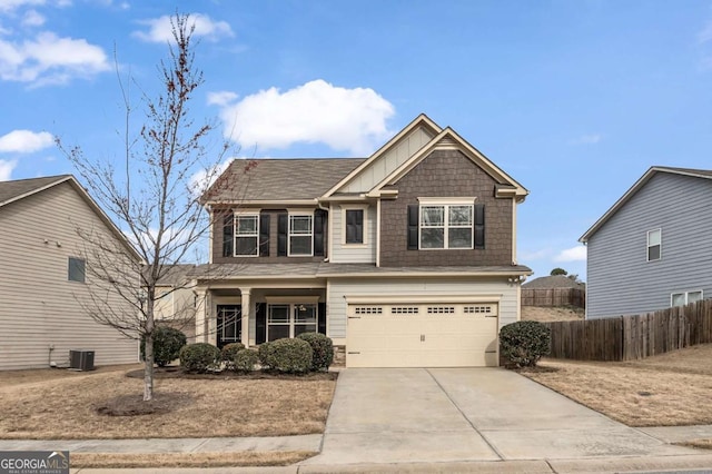 craftsman house featuring an attached garage, central AC unit, board and batten siding, fence, and driveway