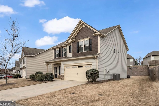 view of front of property with driveway, an attached garage, fence, and cooling unit