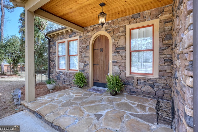 property entrance featuring stone siding