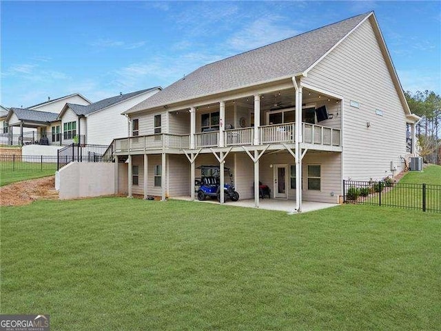 rear view of property featuring a yard, a patio, and a fenced backyard