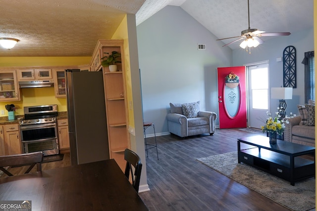 living room with a textured ceiling, visible vents, a ceiling fan, vaulted ceiling, and dark wood-style floors