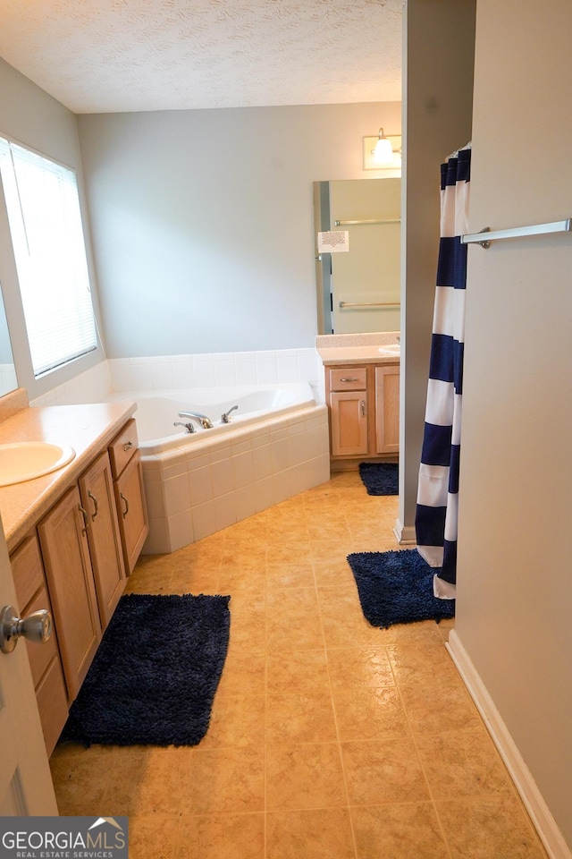 bathroom featuring a shower with curtain, tile patterned floors, a textured ceiling, vanity, and a bath