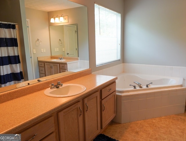 bathroom featuring tile patterned floors, vanity, and a bath