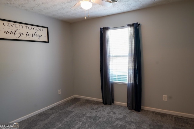 spare room featuring a ceiling fan, carpet, a textured ceiling, and baseboards