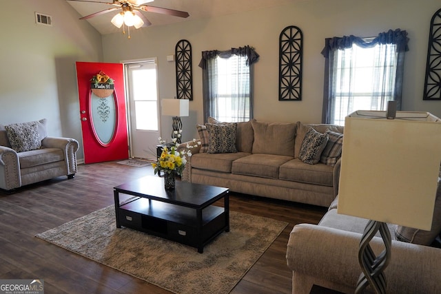 living area featuring a ceiling fan, visible vents, vaulted ceiling, and wood finished floors