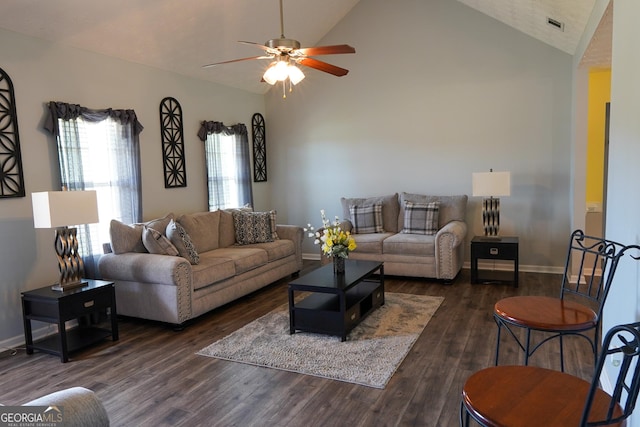 living area with visible vents, a ceiling fan, wood finished floors, high vaulted ceiling, and baseboards