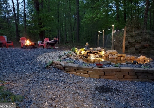 view of yard featuring an outdoor fire pit