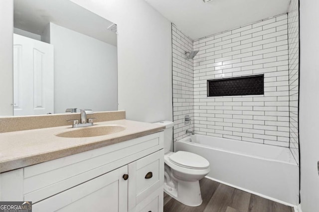 bathroom featuring  shower combination, vanity, toilet, and wood finished floors