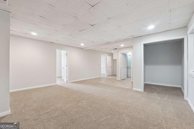 basement with baseboards, recessed lighting, a paneled ceiling, and light colored carpet