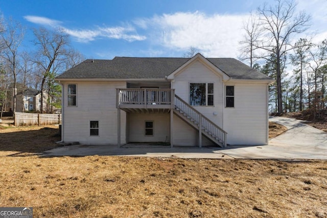 rear view of property featuring a patio, stairway, and a wooden deck