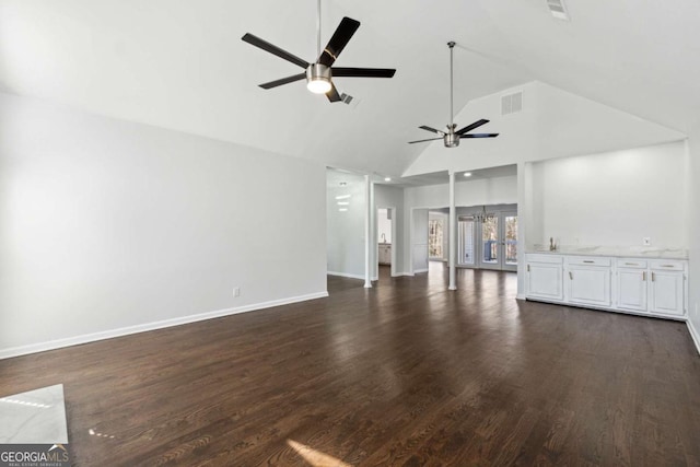 unfurnished living room with a ceiling fan, visible vents, dark wood finished floors, and baseboards