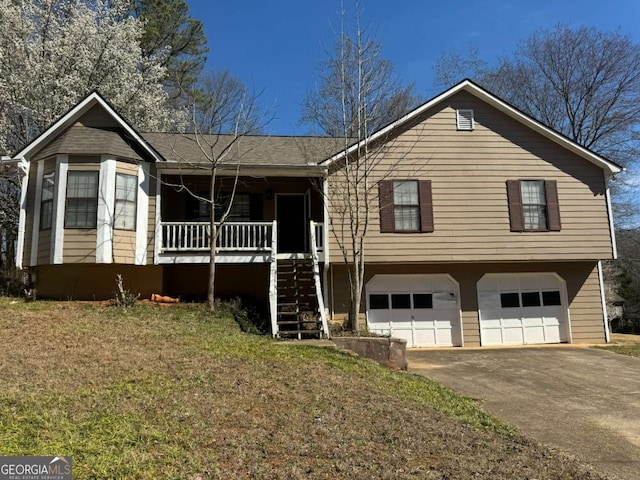 view of front facade with stairs, driveway, a porch, and a garage