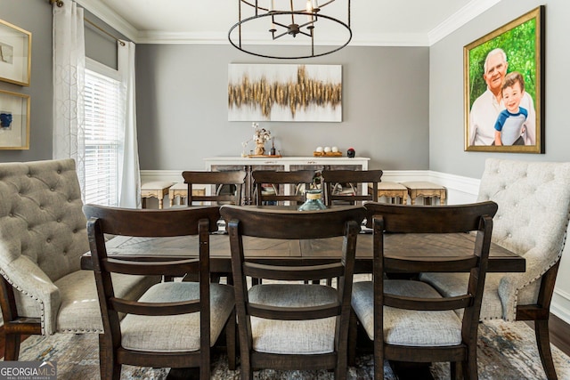 dining room with a chandelier, a wainscoted wall, wood finished floors, and crown molding