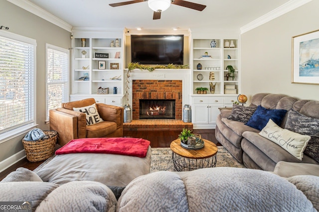 living room featuring a fireplace, wood finished floors, baseboards, built in features, and ornamental molding