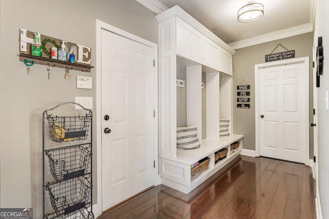 mudroom featuring dark wood-style flooring, crown molding, and baseboards