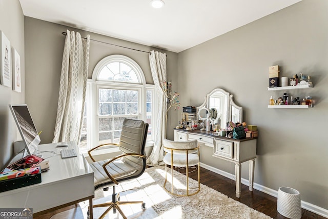 home office with baseboards and wood finished floors