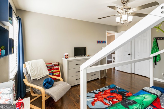 bedroom featuring ceiling fan, wood finished floors, and baseboards