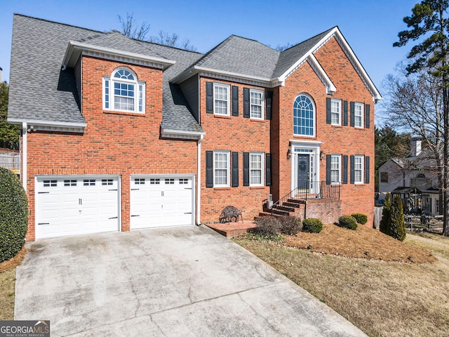 colonial-style house featuring brick siding, concrete driveway, and roof with shingles