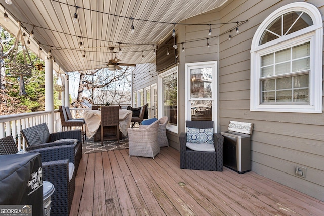 wooden deck with a ceiling fan