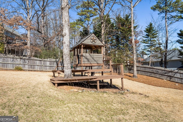 view of yard featuring a fenced backyard and a playground