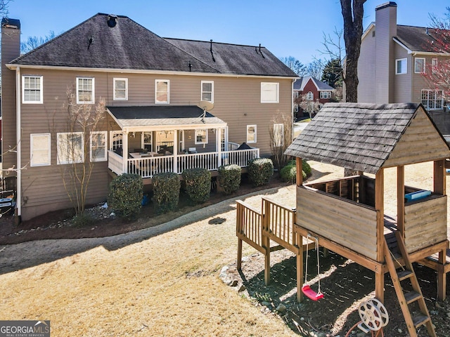 back of property with roof with shingles