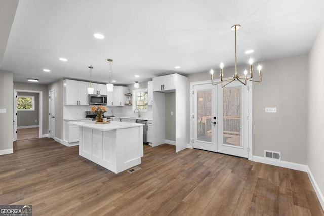 kitchen with white cabinetry, visible vents, appliances with stainless steel finishes, and open shelves