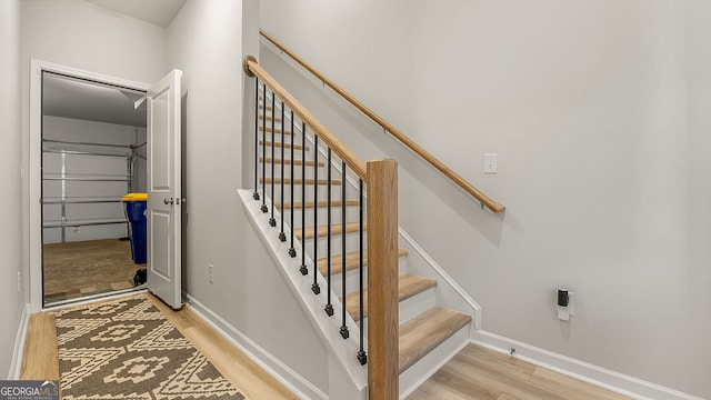 stairs with baseboards and wood finished floors