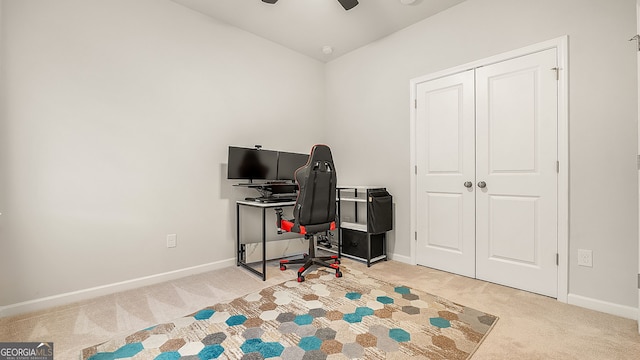 office area with baseboards, ceiling fan, and light colored carpet