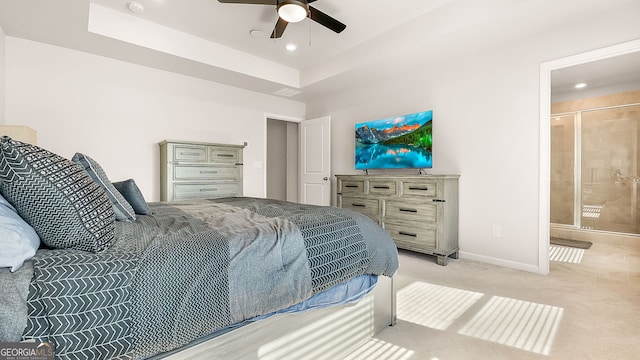 bedroom featuring baseboards, a ceiling fan, light colored carpet, a tray ceiling, and recessed lighting