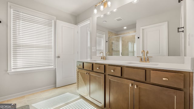 bathroom with a stall shower, visible vents, a sink, and double vanity